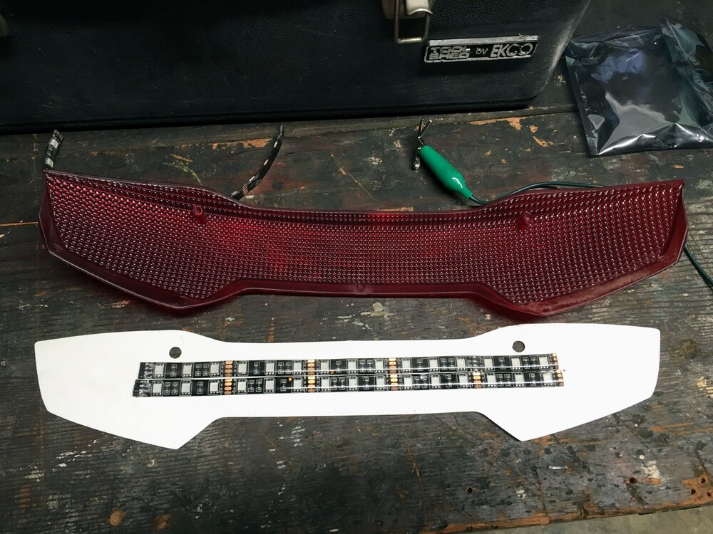 Original 2016 fabrication showing two parallel LED strip runs behind the red reflector