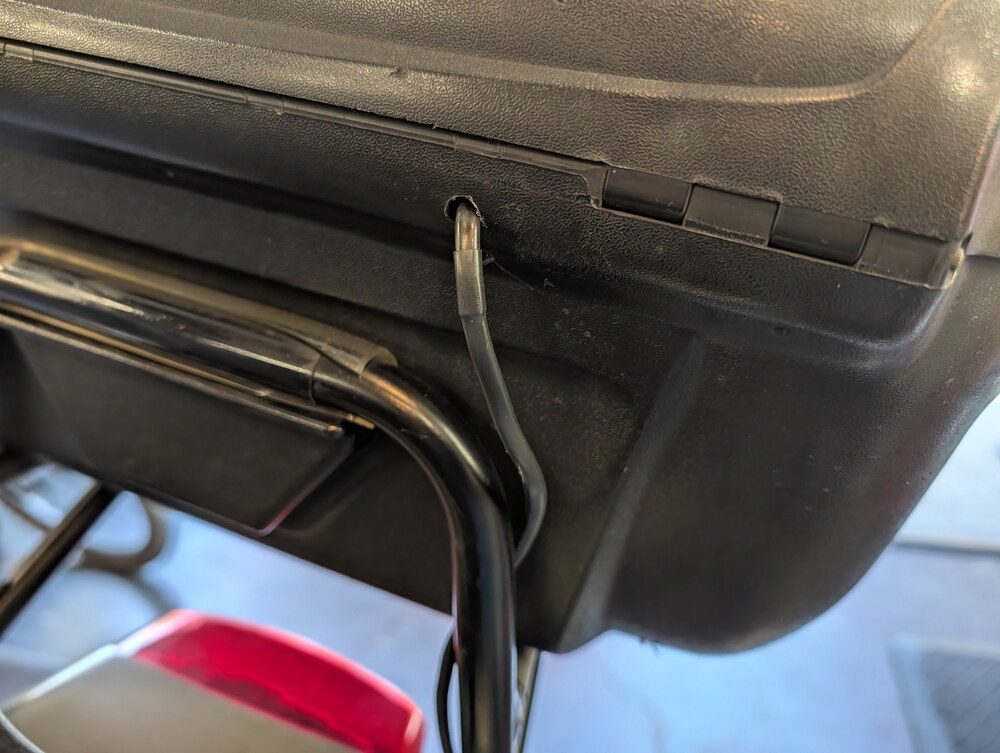 Lighting cable entering the underside of the top case near the hinge